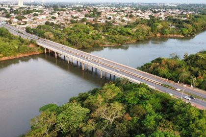 Vista aérea de uma ponte sobre um rio, cercada por vegetação, em Mato Grosso.